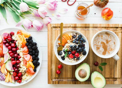 A colorful array of plates filled with fresh fruits and lean proteins, answering the question of what to eat on semaglutide.