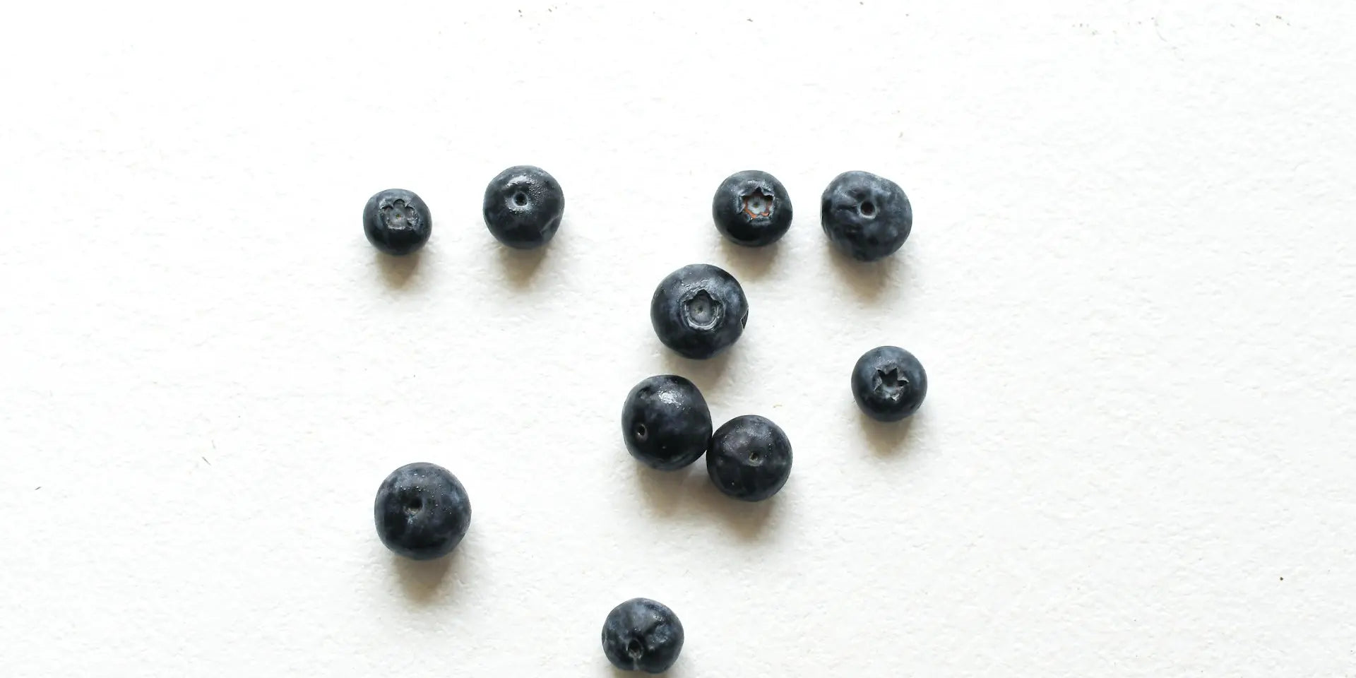 Blueberries on a white table to illustrate healthy snack ideas for busy families