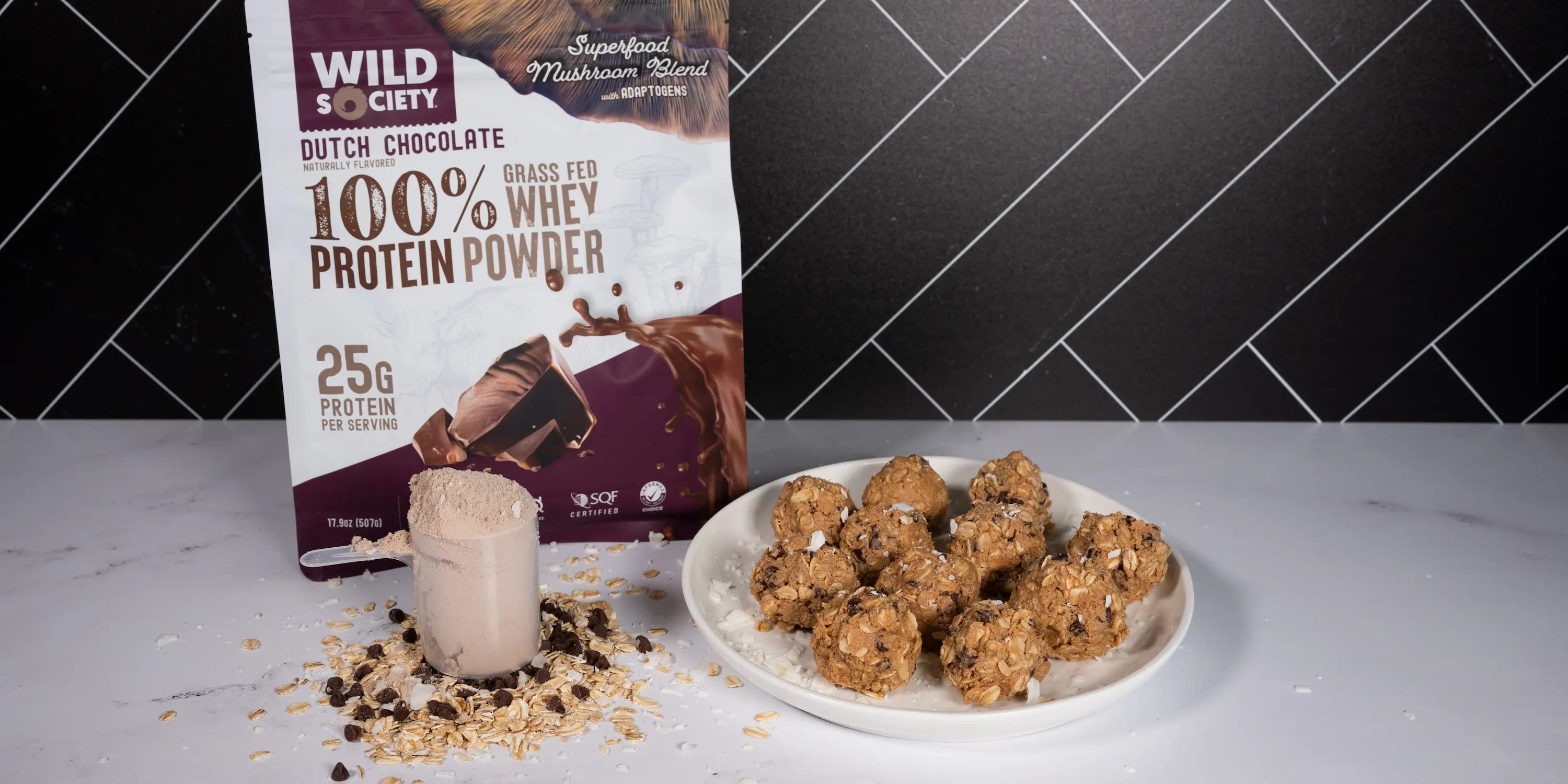 whey protein powder protein balls on a plate next to a package of wild society whey protein powder