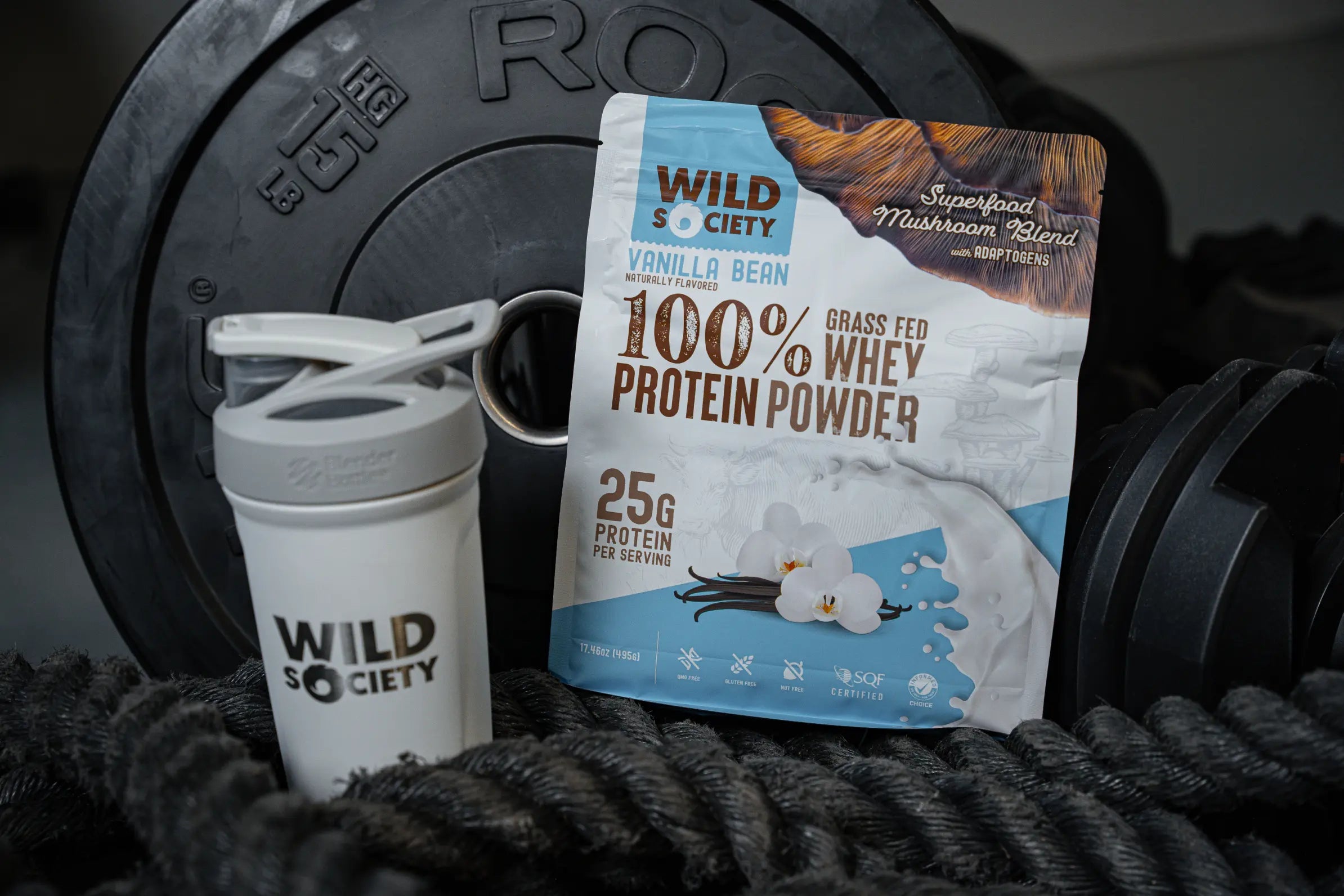 A single-serving package of Wild Society Whey Protein with Mushrooms next to a shaker bottle.
