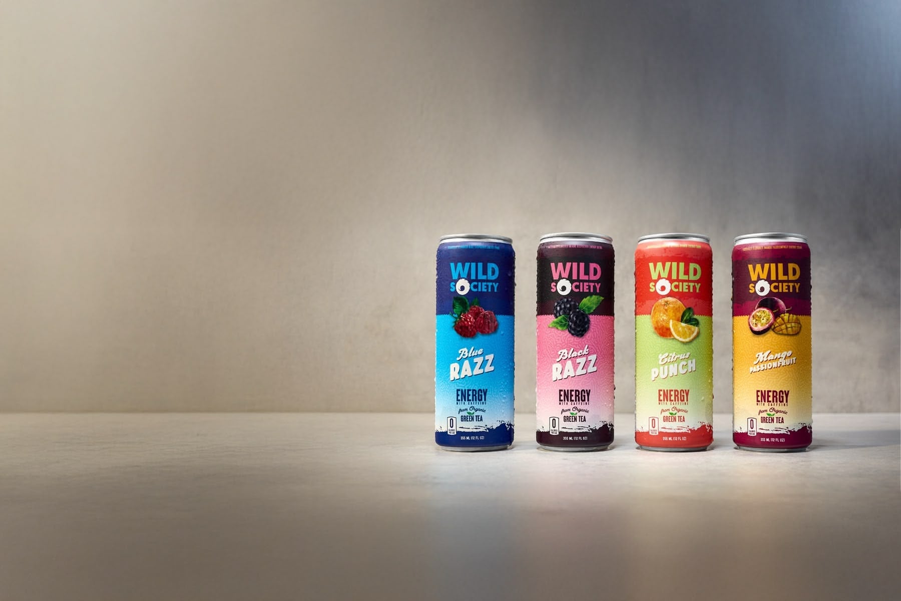 Wild Society energy drink cans on a gray surface with a gradient background