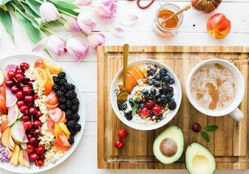 A colorful array of plates filled with fresh fruits and lean proteins, answering the question of what to eat on semaglutide.