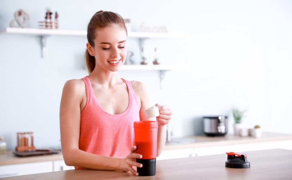 A woman in workout clothes taking a scoop of protein powder to make a morning smoothie and wonder what is the best protein powder for women?