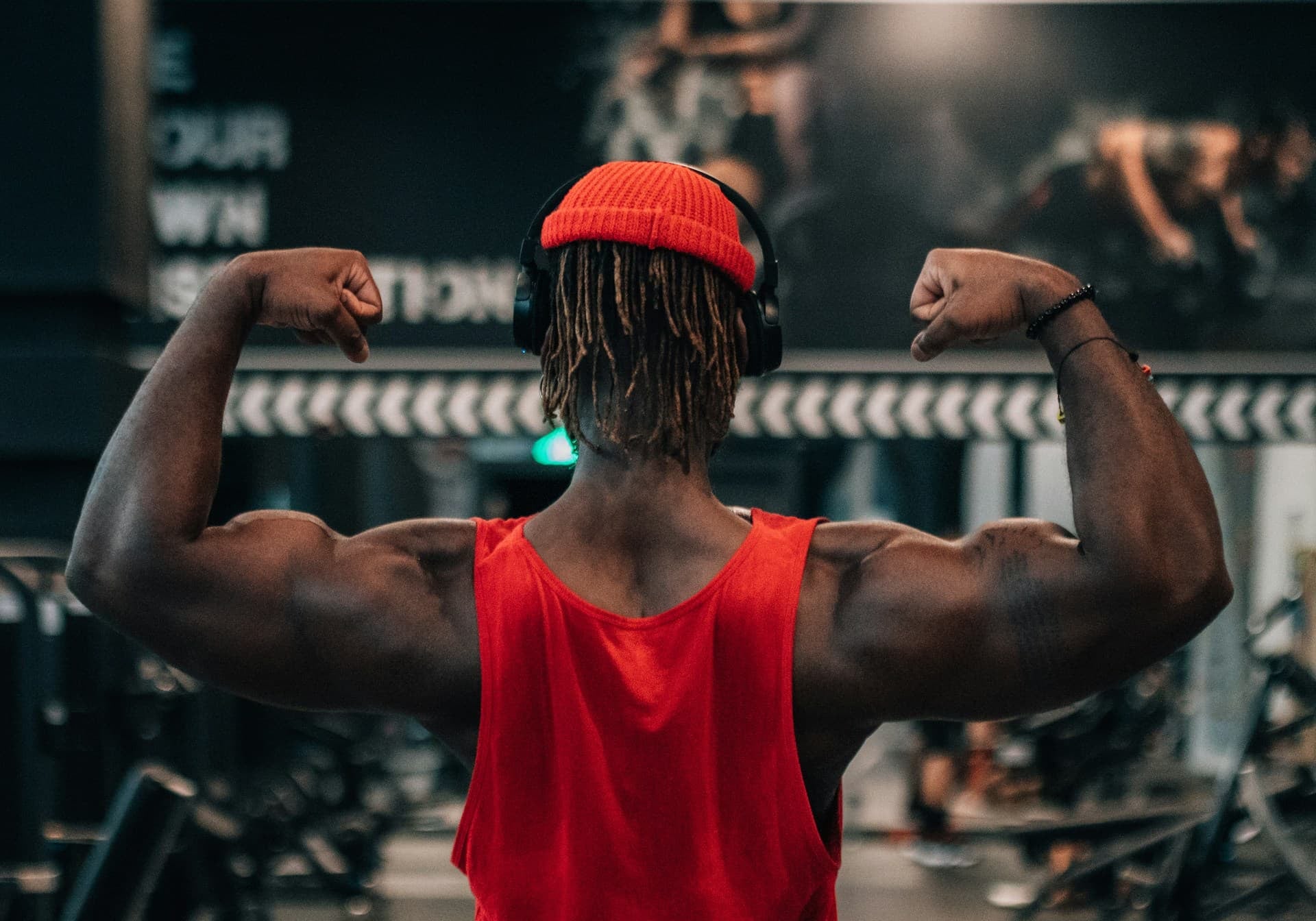 gifts for gym lovers - man at the gym flexing 
