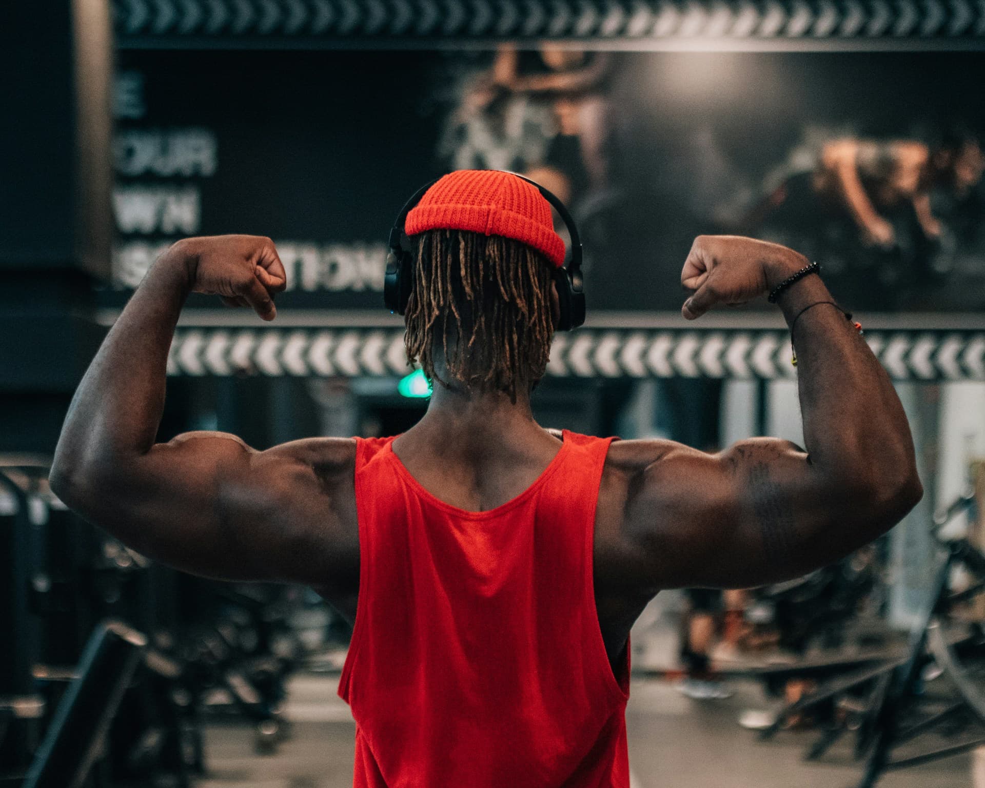 gifts for gym lovers - man at the gym flexing 