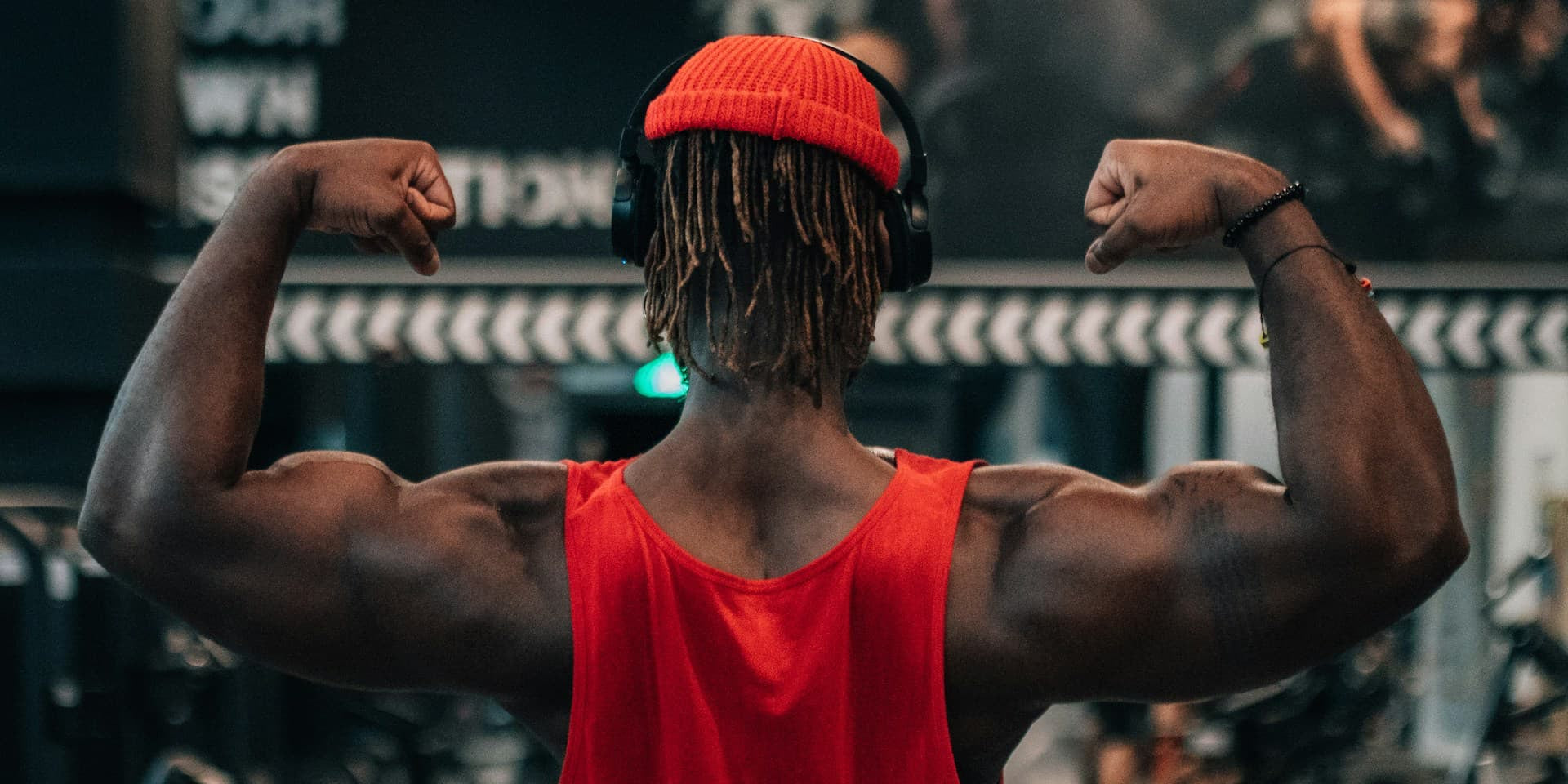 gifts for gym lovers - man at the gym flexing 