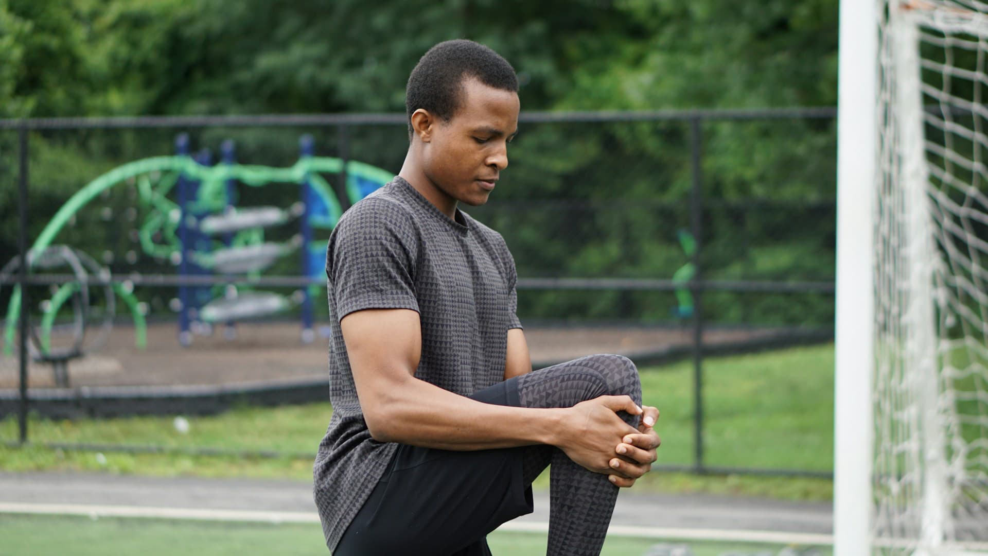 Man stretches on a soccer field and wonders if clean protein is a scam