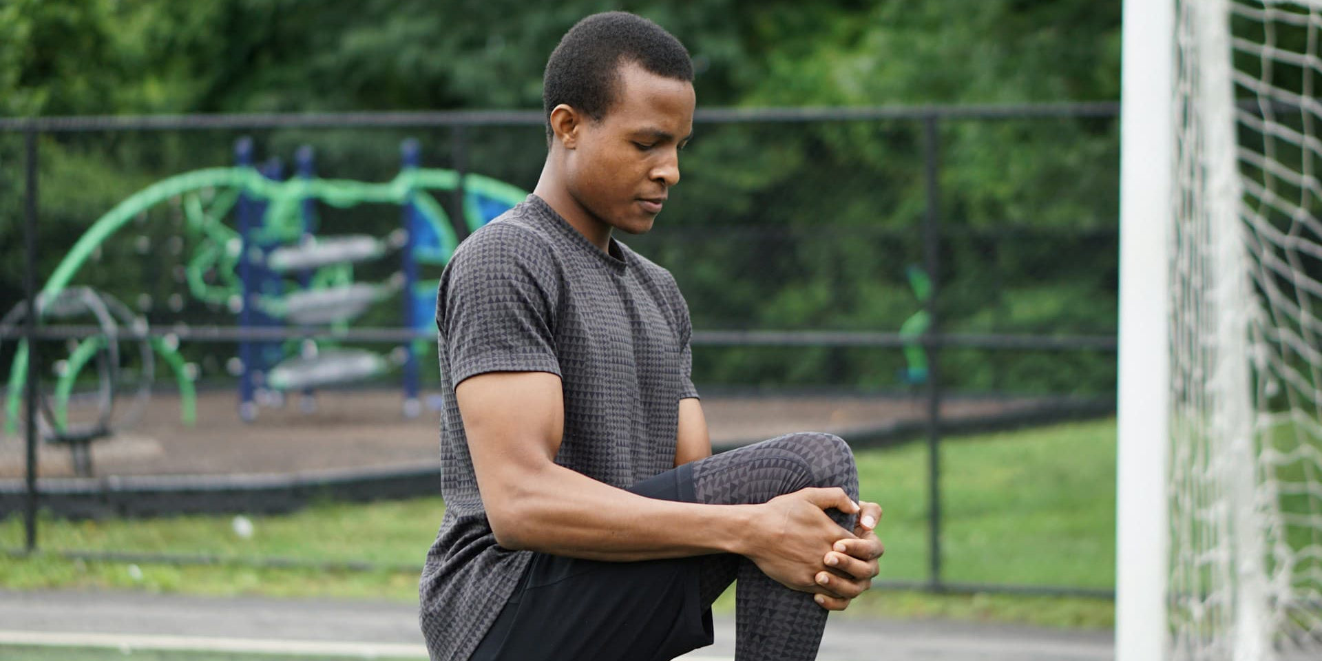 Man stretches on a soccer field and wonders if clean protein is a scam