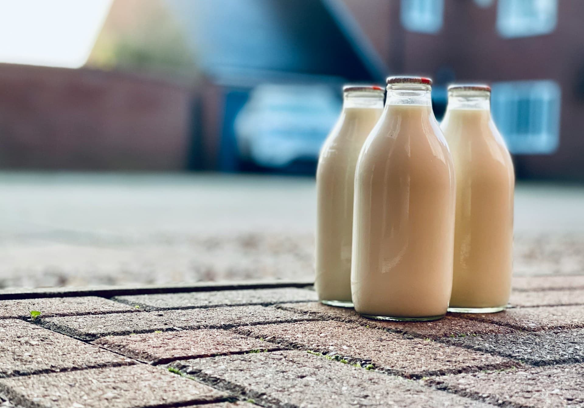 is milk hydrating? three glass milk bottles sit on a patio