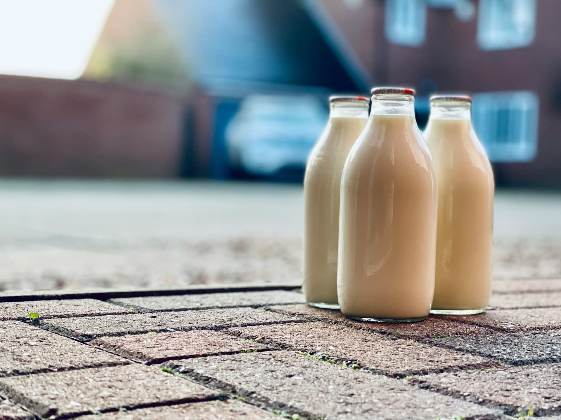 is milk hydrating? three glass milk bottles sit on a patio