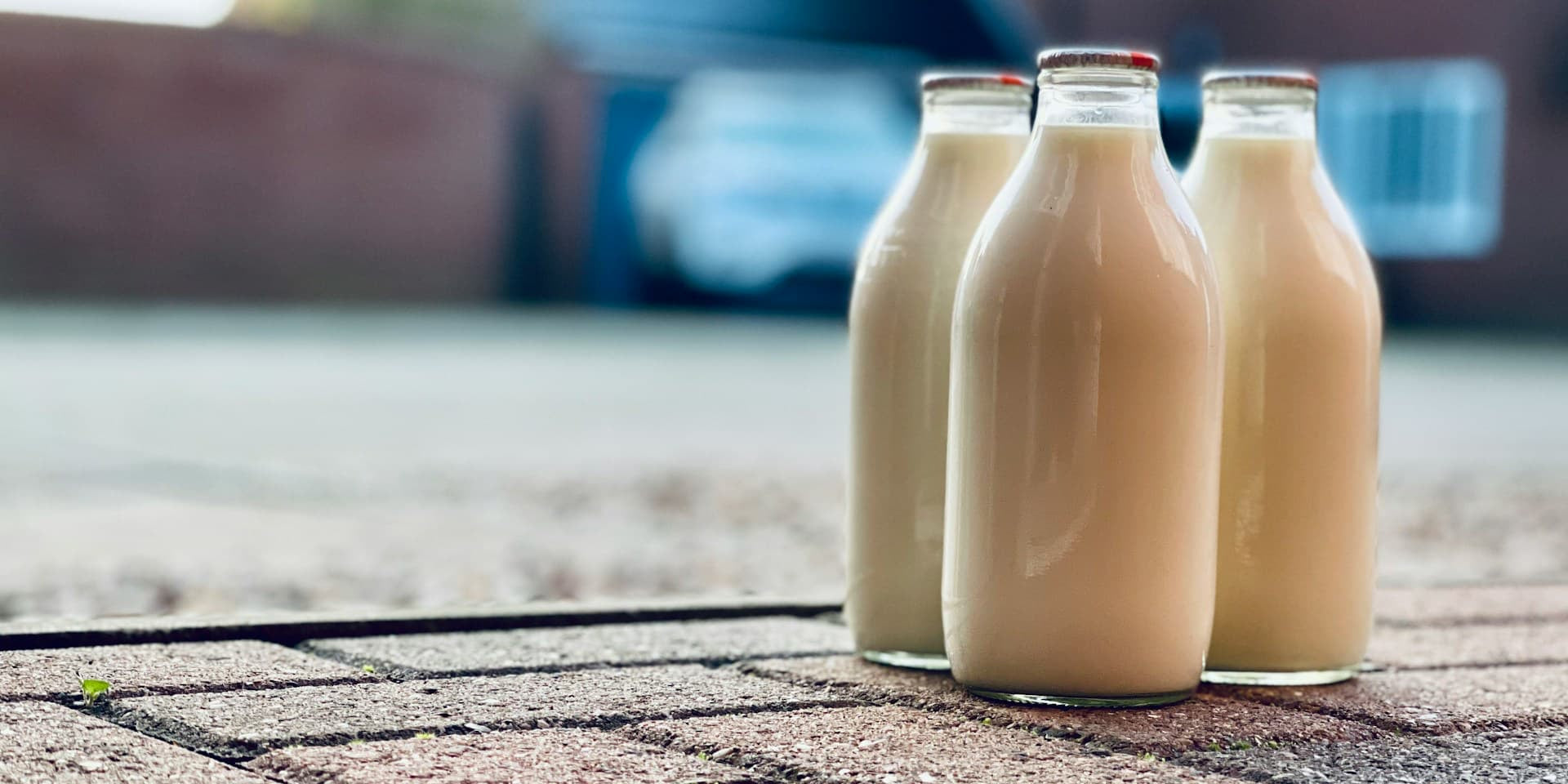 is milk hydrating? three glass milk bottles sit on a patio