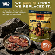 Wild Society Caveman Eats beef jerky package with air-dried beef slices on a rock background