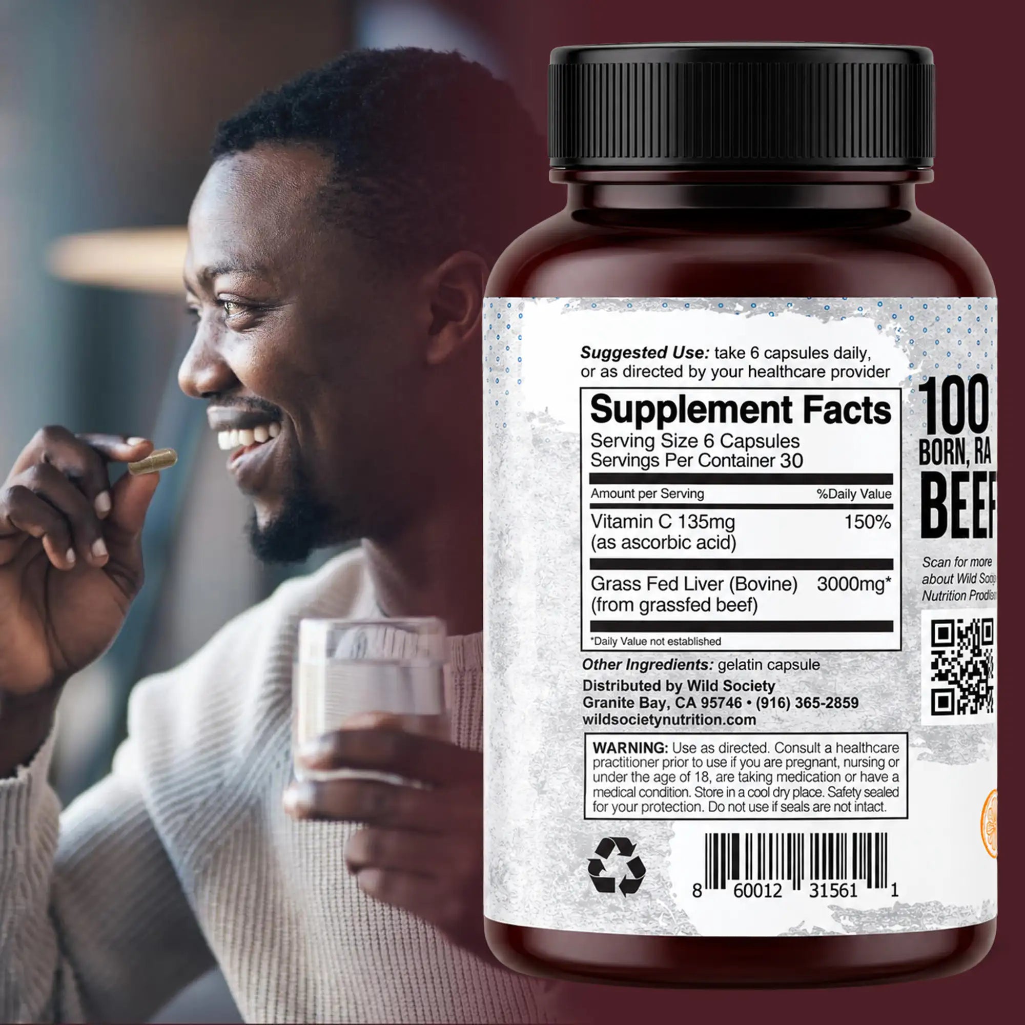 A large bottle of beef supplement capsules shown in front of a lifestyle background featuring a smiling man eating. The bottle has a black cap and a white label with black text, including '100% BORN IN BEEF' and 'Grass Fed Liver (Bovine) 3000mg'.