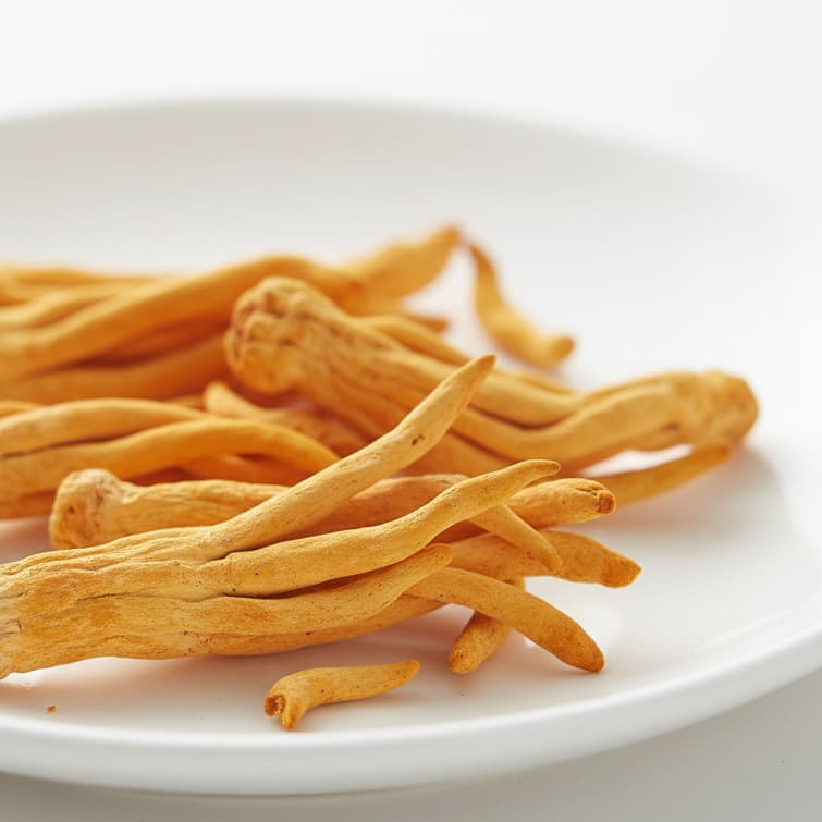 Dried herb on a white plate with a white background